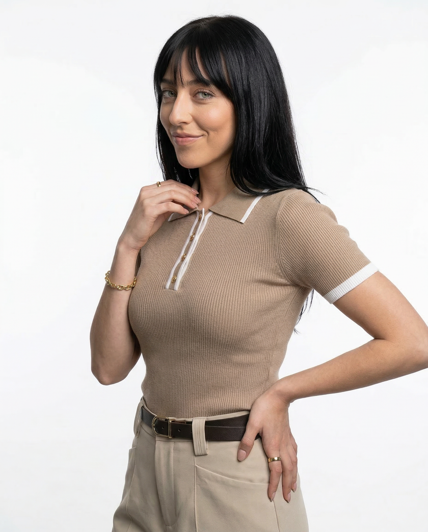 FJØRNA women's cotton polo top, close-up of a classic short-sleeve polo shirt in soft white fabric with a collar.