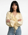 FJØRNA satin women's blouse with ruffle details, elegant top featuring smooth fabric and feminine design.