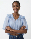 FJØRNA women's cotton blouse with ruffle details, featuring a stylish and breathable top for everyday wear.