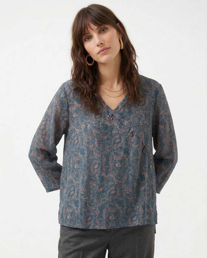 FJØRNA Kaien wrap-style blouse in soft fabric, featuring a V-neck, long sleeves, and a tie waist for a stylish, feminine look.