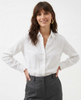 FJØRNA linen blouse for women, lightweight and breathable top with a relaxed fit, shown in soft beige fabric.