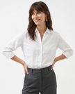 Light beige FJØRNA linen blouse for women, showcasing a relaxed fit and soft fabric, styled as a casual women's top.