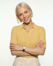 FJØRNA ribbed knit polo blouse for women, showcasing a fitted design with a classic collar and long sleeves.