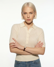 FJØRNA ribbed knit polo blouse for women, featuring a fitted design and classic collar, displayed on a white background.
