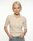 FJØRNA ribbed knit polo blouse for women, showcasing a close-up of the textured ribbed fabric and classic polo collar.