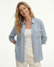 FJØRNA women's long sleeve linen blouse, lightweight and breathable top with a relaxed fit, shown in soft natural fabric.