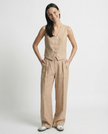FJØRNA linen wide-leg women’s trousers in a relaxed fit, part of a stylish co-ord set, shown in a natural fabric and casual design.