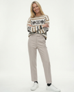 FJØRNA women's wool blend trousers featuring a tailored fit and classic design, displayed on a model in a casual setting.