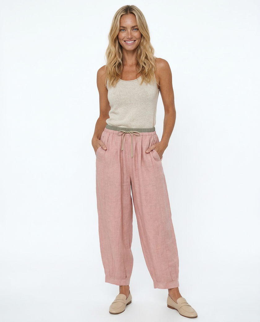 FJØRNA women's linen tapered trousers showing lightweight, beige fabric and relaxed fit, perfect for casual or summer wear.