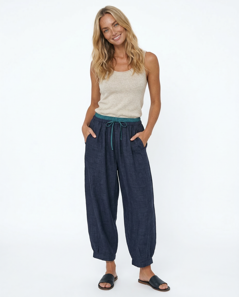 FJØRNA women's linen tapered trousers, lightweight pant with a relaxed fit and natural fabric texture, perfect for casual wear.