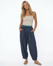 FJØRNA women's linen tapered trousers, stylish and comfortable pants, shown in a natural beige color with a relaxed fit.