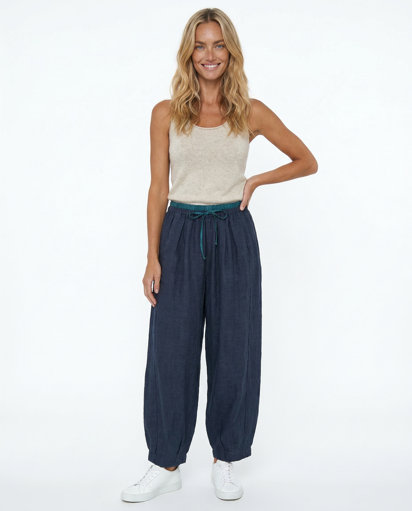 FJØRNA women's linen tapered trousers, stylish and comfortable pants, displayed with a relaxed fit and natural fabric texture.