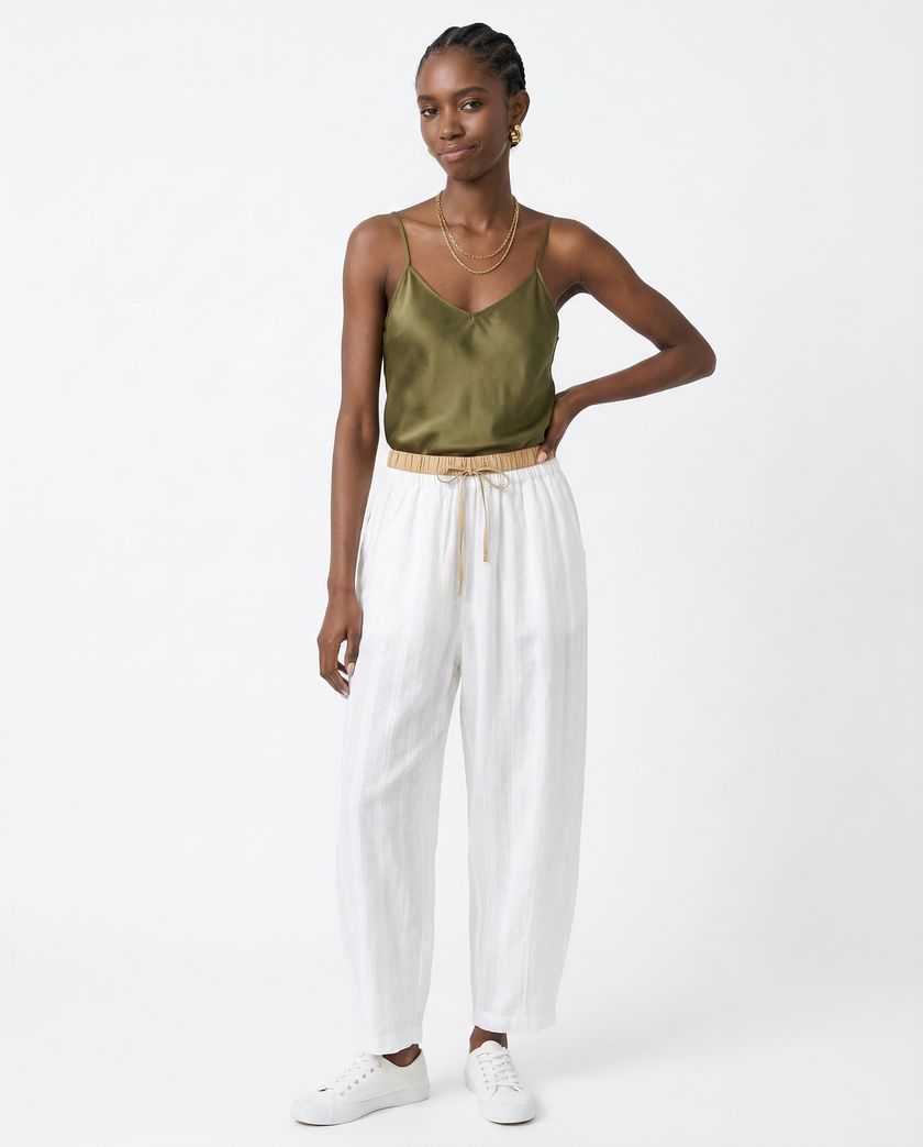 FJØRNA women's linen tapered trousers, front view showing lightweight fabric, high waist, and relaxed fit.