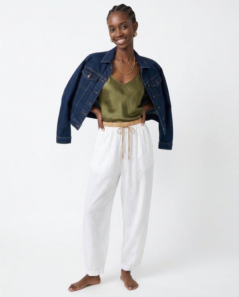 FJØRNA women's linen tapered trousers displayed, featuring a relaxed fit and natural fabric texture with a neutral color.
