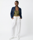 FJØRNA women's linen tapered trousers, stylish and breathable pants, shown in a relaxed fit with natural fabric texture.