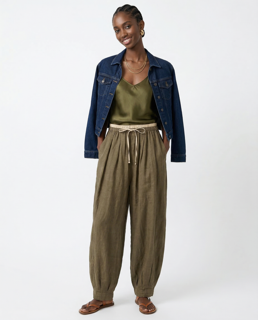 FJØRNA women's linen tapered trousers with a relaxed fit, light fabric, and a stylish, modern design for casual wear.