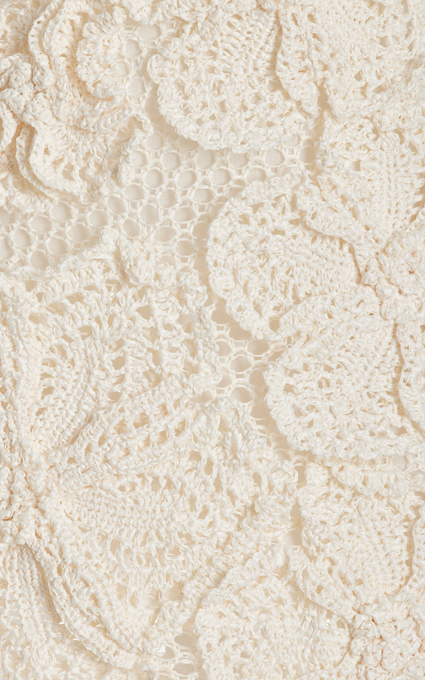FJØRNA Kendria floral crochet mini dress with intricate floral pattern, short sleeves, and fitted silhouette.