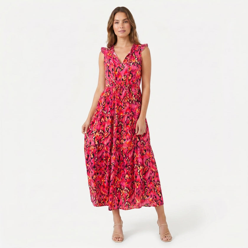 Women's sleeveless floral print boho maxi dress with tie neck by FJØRNA, featuring a flowing silhouette and vibrant pattern.