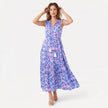 Women's sleeveless floral print boho maxi dress with tie neck from FJØRNA, featuring a flowing silhouette and vibrant floral pattern.