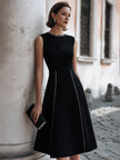 FJØRNA sleeveless A-line midi dress with chain-trim seams, showcasing a flowing silhouette and stylish design.