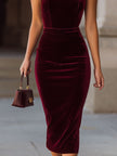 FJØRNA rich burgundy velvet halter-neck bodycon midi dress, elegant sleeveless dress with a fitted silhouette and soft velvet fabric.