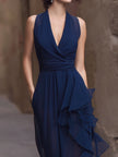 Navy deep V-neck ruffled chiffon maxi dress by FJØRNA featuring flowing fabric and elegant design, displayed on a hanger.