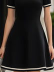 FJØRNA mock neck fit and flare mini dress with contrast trim, perfect for weddings or special occasions, shown on a model.