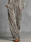 Grey velvet leopard print hooded wide-leg jumpsuit by FJØRNA, featuring a relaxed fit and stylish design.