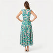 FJØRNA women's sleeveless floral print tie neck boho maxi dress displayed on a model, featuring a flowing silhouette and vibrant pattern.