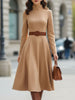 FJØRNA elegant camel turtleneck belted midi dress displayed on a model, showcasing the sleek design and stylish fit.