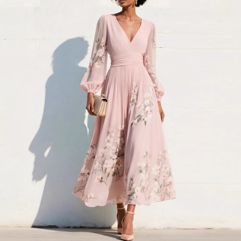 FJØRNA floral print long-sleeved V-neck pleated dress with elegant design and vibrant floral pattern on lightweight fabric.
