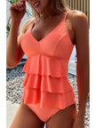 Women's summer V-neck swimsuit with ruffles by FJØRNA, featuring a sleeveless design and stylish ruffle details.