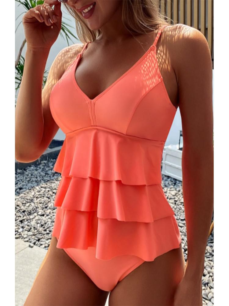 Women's summer V-neck swimsuit with ruffles by FJØRNA, featuring a sleeveless design and stylish ruffle details.