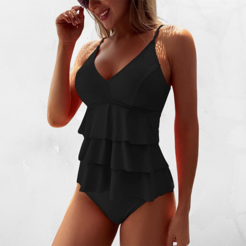 Women's summer V-neck swimsuit with ruffles by FJØRNA, featuring a stylish design and ruffle details.