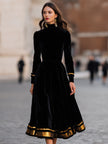 FJØRNA elegant velvet midi dress with gold trim, showcasing a fitted silhouette and luxurious fabric.