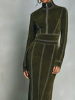 FJØRNA olive green high neck zip-up midi dress with contrast stitching, featuring a fitted silhouette and stylish design.