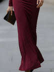 FJØRNA elegant long-sleeve draped cutout evening gown, a stylish maxi dress with flowing fabric and sophisticated design.