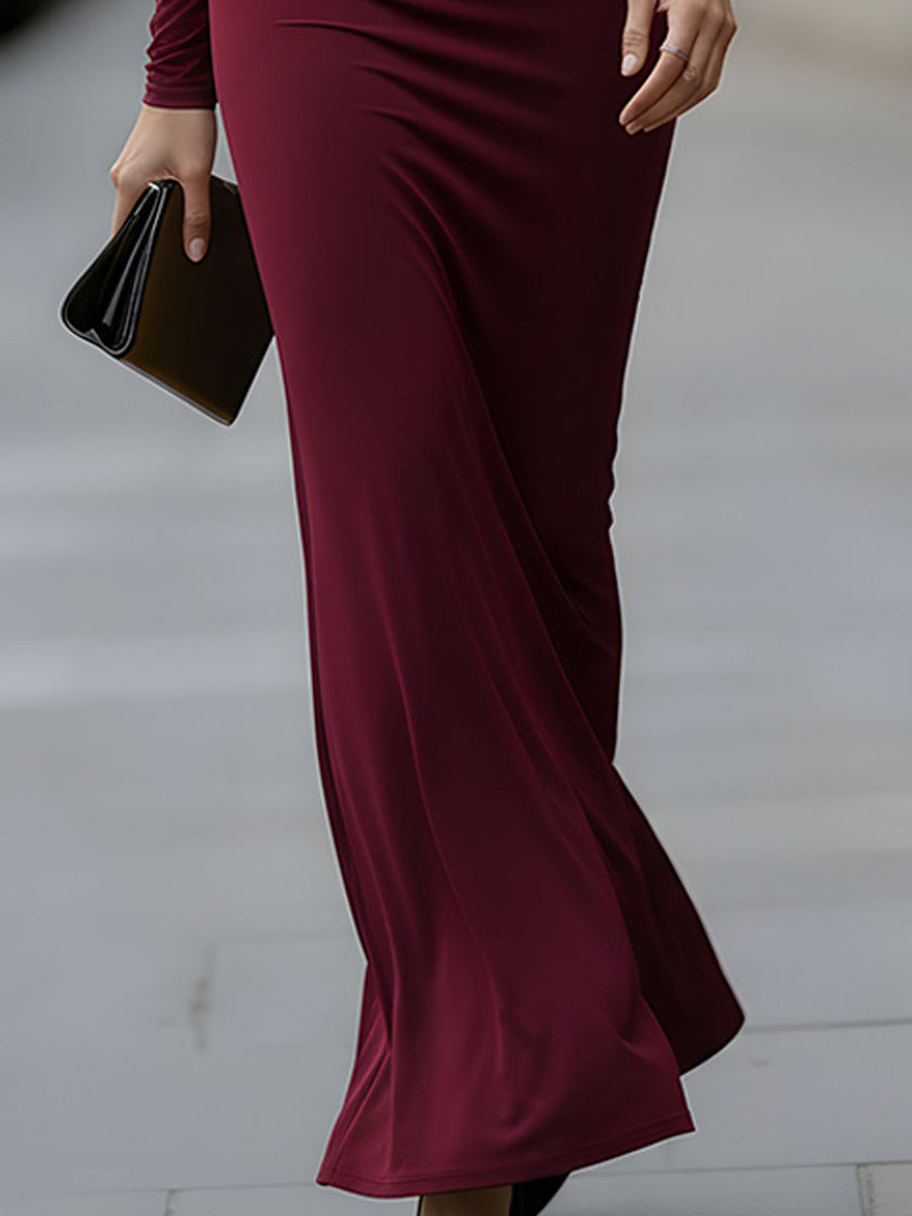 FJØRNA elegant long-sleeve draped cutout evening gown, a stylish maxi dress with flowing fabric and sophisticated design.