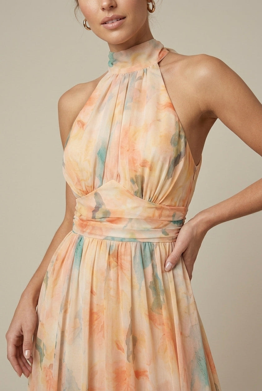 Close-up of FJØRNA women's floral halter neck maxi dress with tie back, showcasing detailed fabric and elegant design for wedding guest attire.