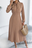 FJØRNA solid color long-sleeved fitted waist pleated midi dress displayed on a hanger, showcasing elegant design and feminine silhouette.