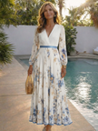 FJØRNA floral summer maxi dress for women with long sleeves, flowing fabric and vibrant flower pattern, perfect for warm weather.
