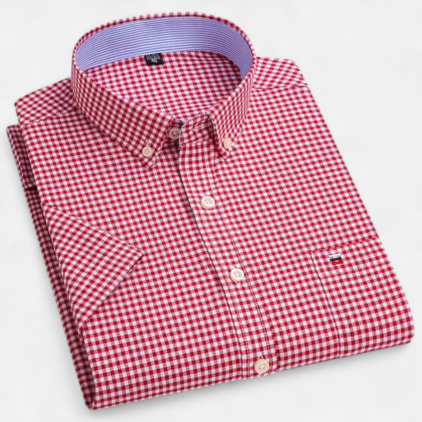 FJØRNA men's short sleeve Oxford cotton button-up shirt in light blue, showing collar and front button details.