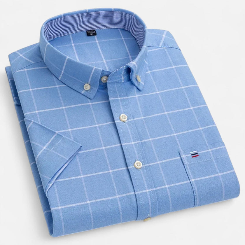 Men's FJØRNA Oxford cotton short sleeve button-up shirt displayed on a hanger, with a classic collar and button front.