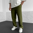 FJØRNA relaxed knit trousers in khaki, showing soft fabric and comfortable fit, styled with a casual waist and tapered leg.