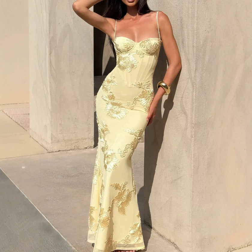 Women's floral jacquard corset maxi dress by FJØRNA, featuring a fitted bodice, floral pattern, and flowing length, displayed on a model.