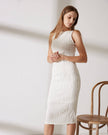 Red FJØRNA midi dress for women with pearl straps and textured water ripple design, shown on a model.
