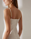 Red FJØRNA midi dress for women with pearl straps and water ripple textured fabric, shown on a hanger.
