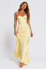 Women's floral jacquard corset maxi dress by FJØRNA, featuring intricate floral patterns and a fitted bodice, flowing length.