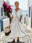 Lightweight FJØRNA women's summer midi dress with V-neck, short sleeves, and flowing fabric, perfect for warm weather.