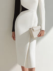 FJØRNA black and white asymmetrical one-shoulder midi dress displayed on a mannequin, showcasing its elegant design and unique silhouette.